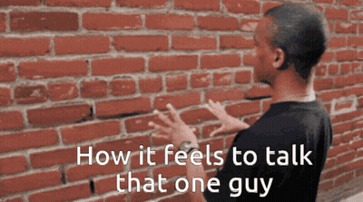 Man In Front Of Red Brick Wall Saying How It Feels To Talk That One Guy GIF