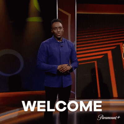 Man In Front Of Screen Saying Welcome GIF