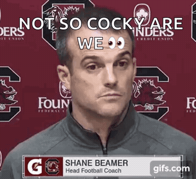 Man In Front Of Shane Beamer Banner GIF