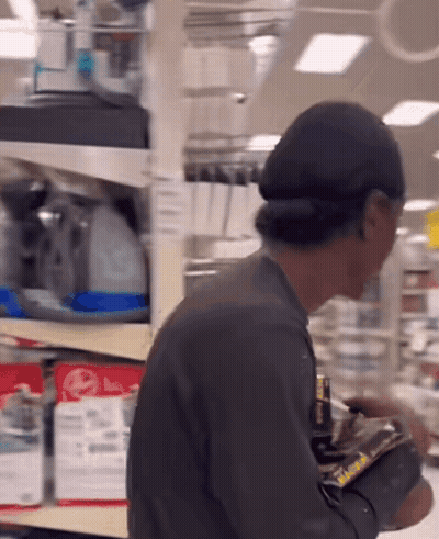 Man In Front Of Shelf With LG Sign GIF