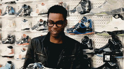 Man In Front Of Shoe Wall With Complex Sign GIF