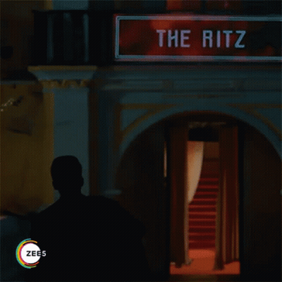 Man In Front Of Sign Reading The Ritz GIF