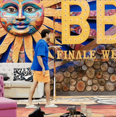 Man In Front Of Sign Saying Finale Week GIF