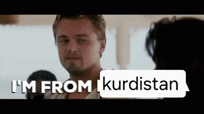 Man In Front Of Sign Saying I'm From Kurdistan GIF