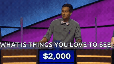Man In Front Of Sign Saying What Is Things You Love To See Alex $2,000 GIF