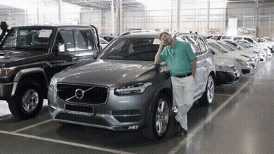 Man In Front Of Silver Volvo Car GIF
