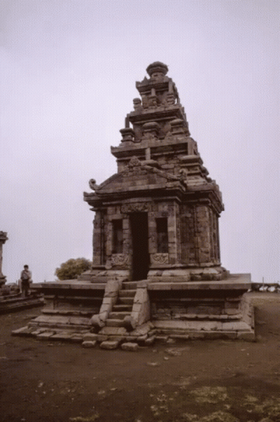 Man In Front Of Stone Temple With Gray Sky GIF
