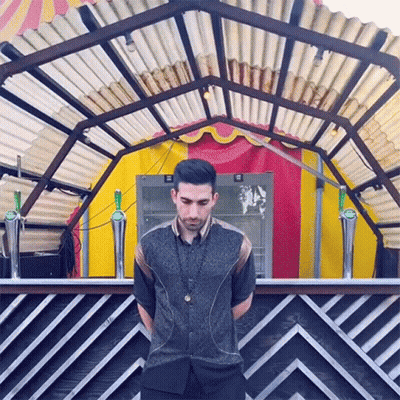 Man In Front Of Striped Wall With Heineken Bottle GIF