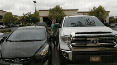 Man In Front Of Toyota Truck And Hyundai Car GIF