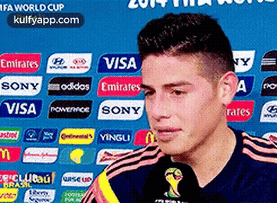 Man In Front Of Visa Emirates Sony Adidas Sign GIF