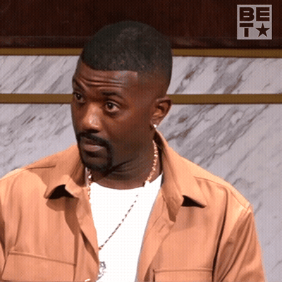 Man In Front Of Wall With Be T Logo GIF