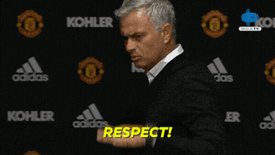 Man In Front Of Wall With Kohler And Adidas Logos GIF
