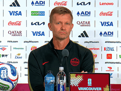 Man In Front Of Wall With Qatar Airways And Visa Sponsors GIF