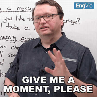 Man In Front Of White Board Saying Give Me A Moment Please GIF