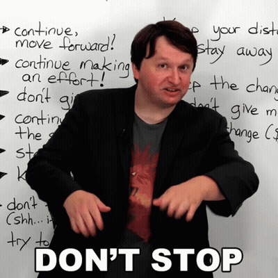 Man in Front of Whiteboard Saying Don't Stop