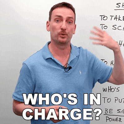 Man In Front Of Whiteboard Saying Who's In Charge GIF