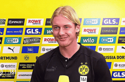 Man In Front Of Yellow Wall With Rowe Wilo Ads GIF