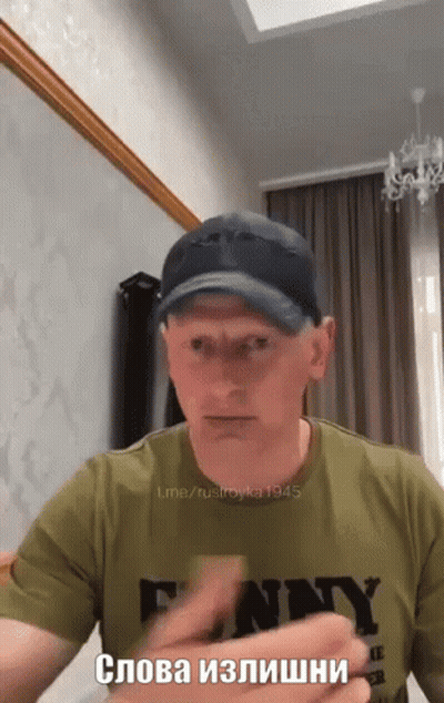 Man In Funny T-Shirt And Baseball Cap GIF