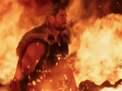 Man In Fur Cape Standing In Front Of Fire GIF