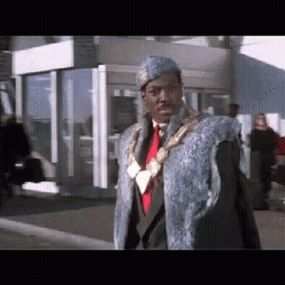 Man In Fur Coat And Tie Walking GIF