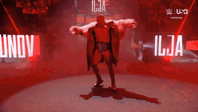Man In Fur Coat Dancing In Front Of Ilja Sign GIF