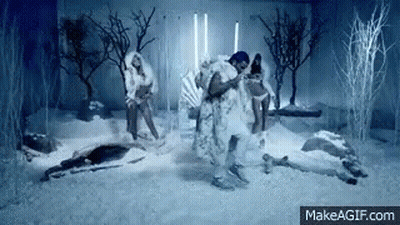 Man In Fur Coat Dancing In Snow With Two Women GIF