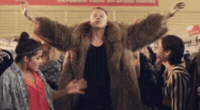 Man In Fur Coat Dancing With Two Women In Store GIF