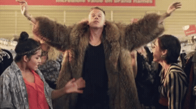 Man In Fur Coat Dancing With Two Women GIF