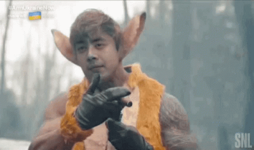 Man In Fur Coat Holding Gun GIF