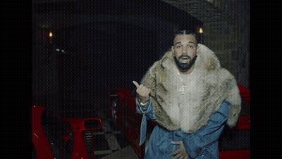 Man In Fur Coat In Front Of Red Car GIF