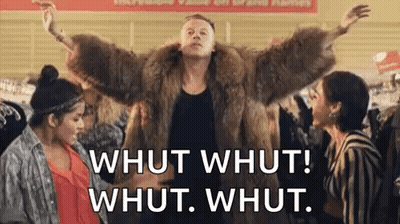 Man In Fur Coat Standing Before Two Women In Store GIF
