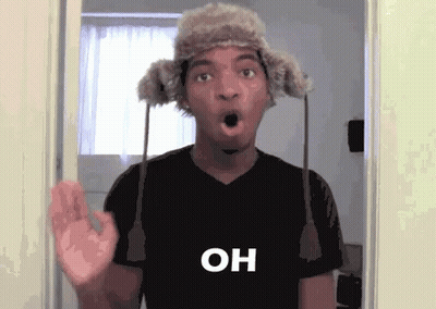 Man In Fur Hat And Black Shirt Surprised In Doorway GIF