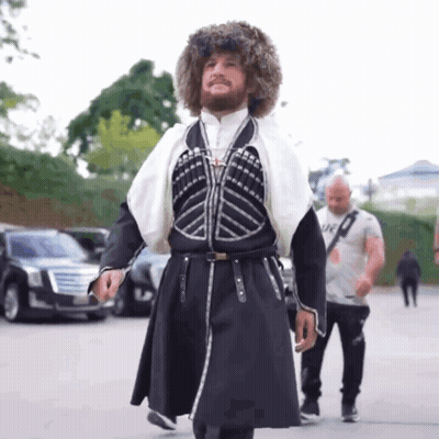Man In Fur Hat And Black White Costume GIF