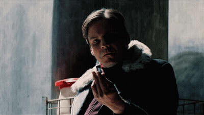 Man in Fur Jacket Holding Blue Object