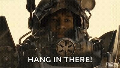 Man In Futuristic Helmet Holding Gun Saying Hang In There GIF