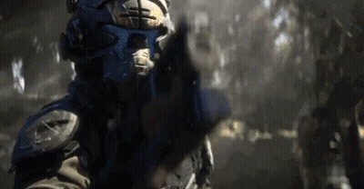 Man In Futuristic Helmet Pointing Gun GIF