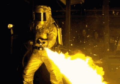 Man In Gas Mask Holding Flamethrower GIF