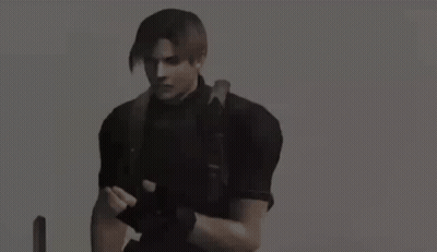 Man In Gas Mask Kneeling In Field Holding Camera GIF