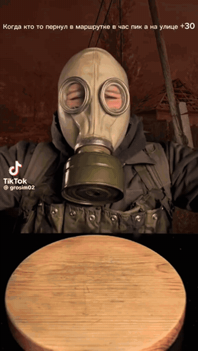 Man In Gas Mask Next To Cutting Board GIF