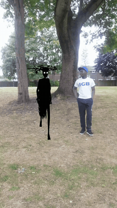 Man In GB Shirt Standing In Front Of Tree GIF