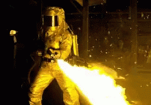 Man In Gear Flamethrower GIF