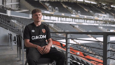 Man In Giacom Shirt Sitting In Chair GIF