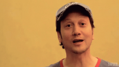 Man In Giants Hat Points At Camera GIF