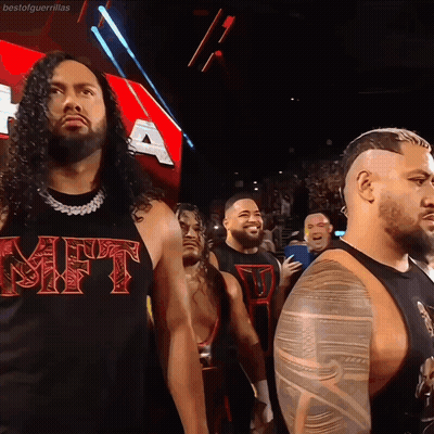 Man In Gift Shirt Stands Before Crowd GIF