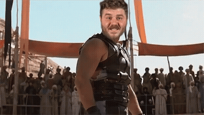 Man In Gladiator Costume In Front Of Crowd GIF
