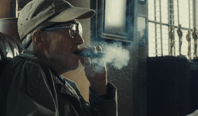 Man In Glasses And Baseball Cap Smoking Cigar GIF