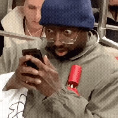 Man In Glasses And Beanie Looking At Phone GIF