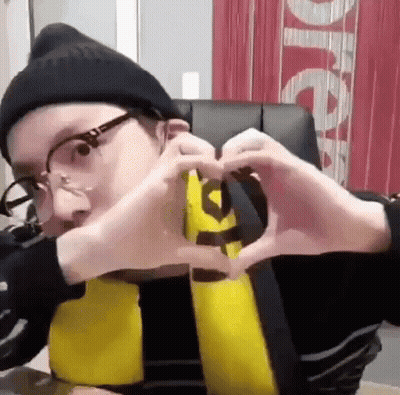Man In Glasses And Beanie Making Heart GIF