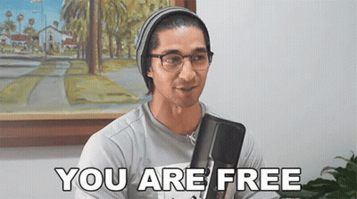 Man In Glasses And Beanie Saying You Are Free GIF