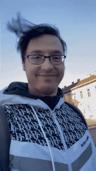 Man In Glasses And Black And White Jacket Says Black Light GIF